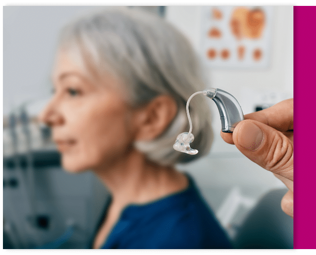 Woman getting her hearing aid fitted at her local hearing clinc